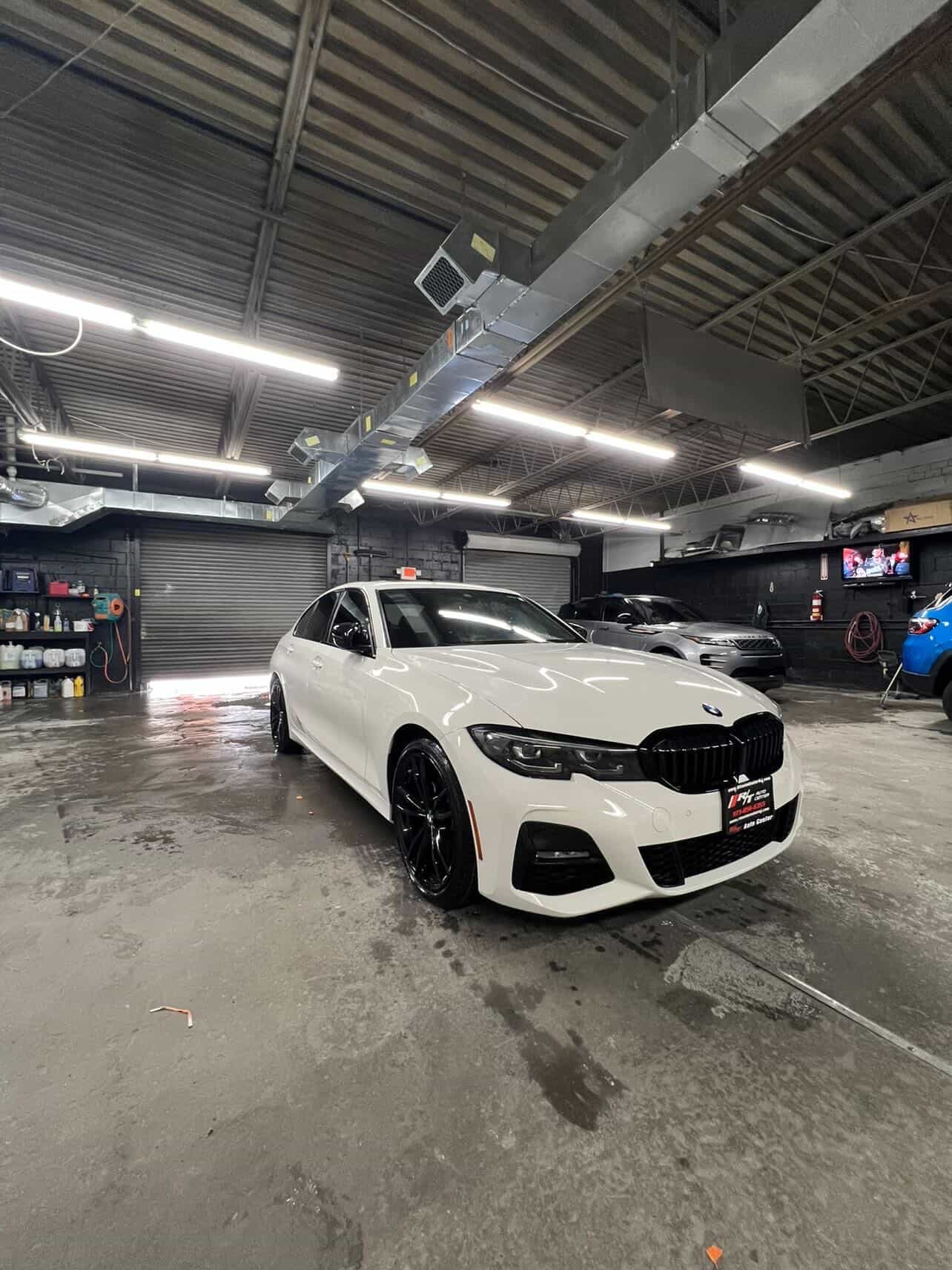 White performance coupe inside the Barbosa Auto Body shop